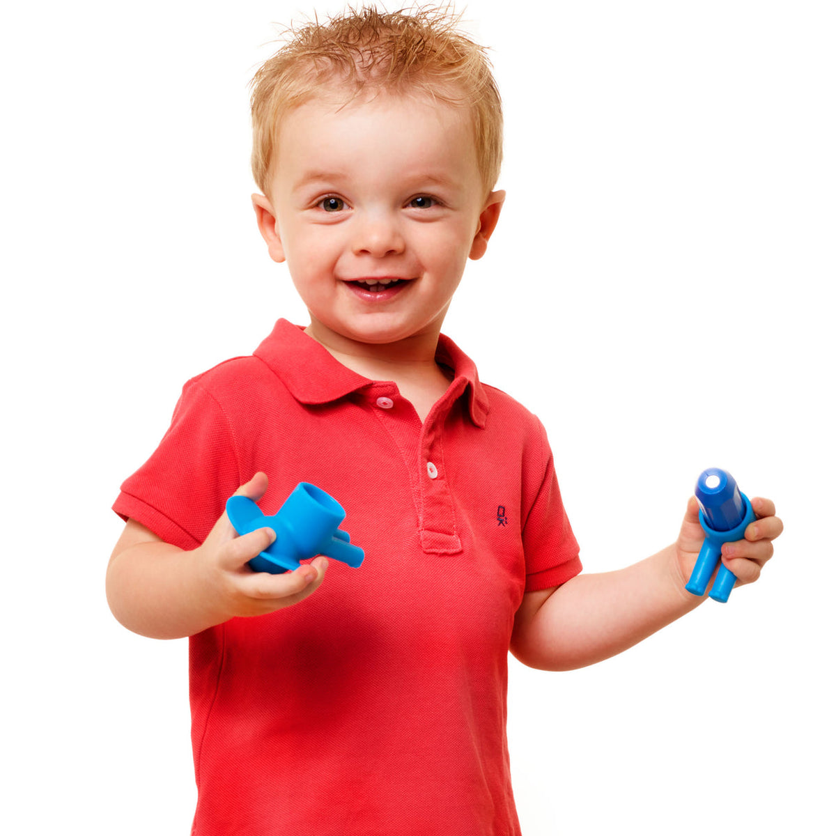 Child in a red shirt holding blue toys against a white background