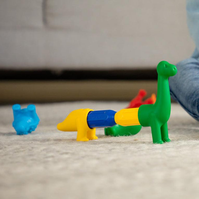 Colorful toy dinosaurs on a carpeted floor