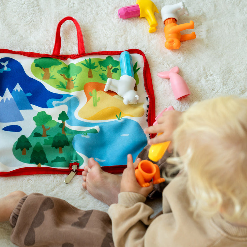 Child playing with a colorful educational toy on a light surface