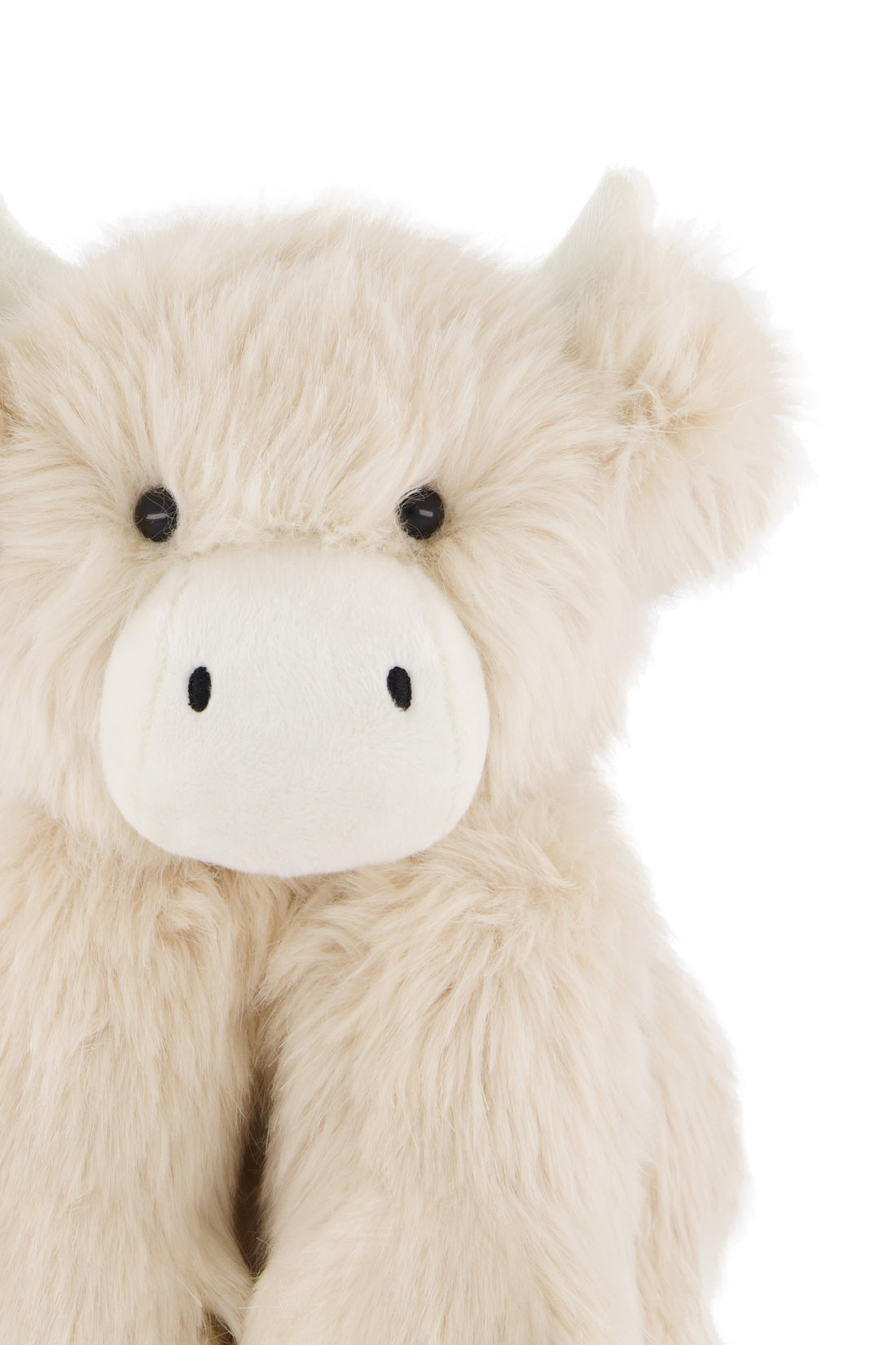 Plush toy cow with a white face on a white background