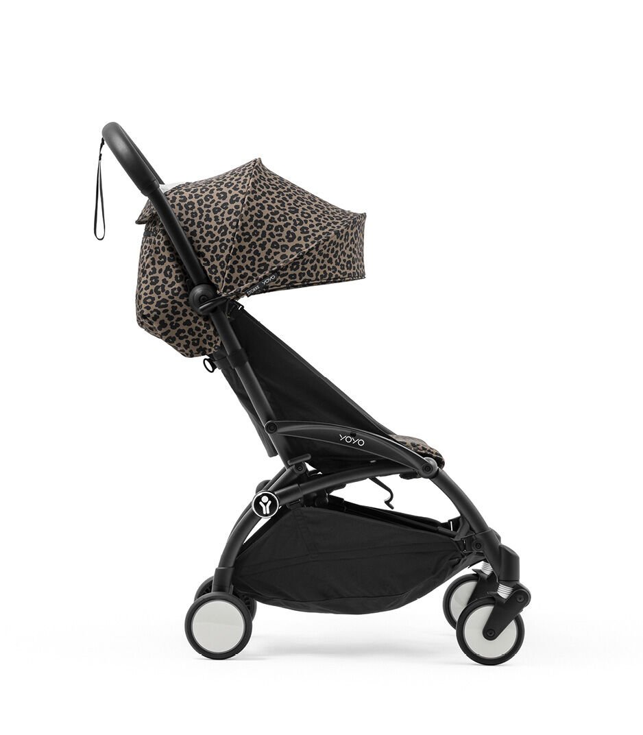 Black stroller with leopard print canopy on a white background