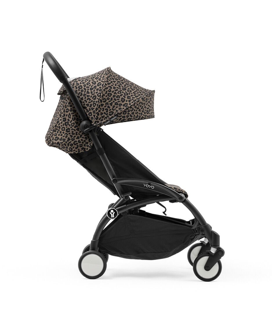 Black stroller with leopard print canopy on a white background