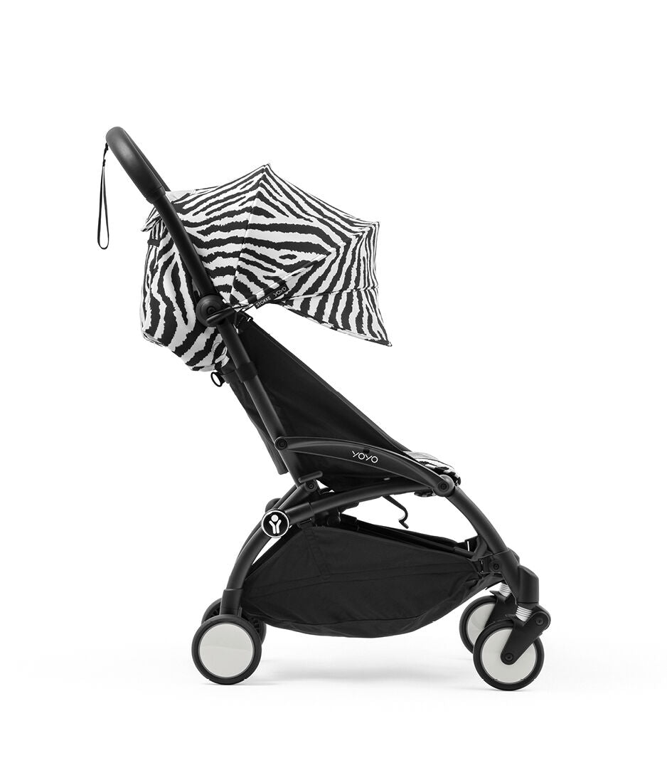 Black stroller with zebra-patterned canopy on a white background