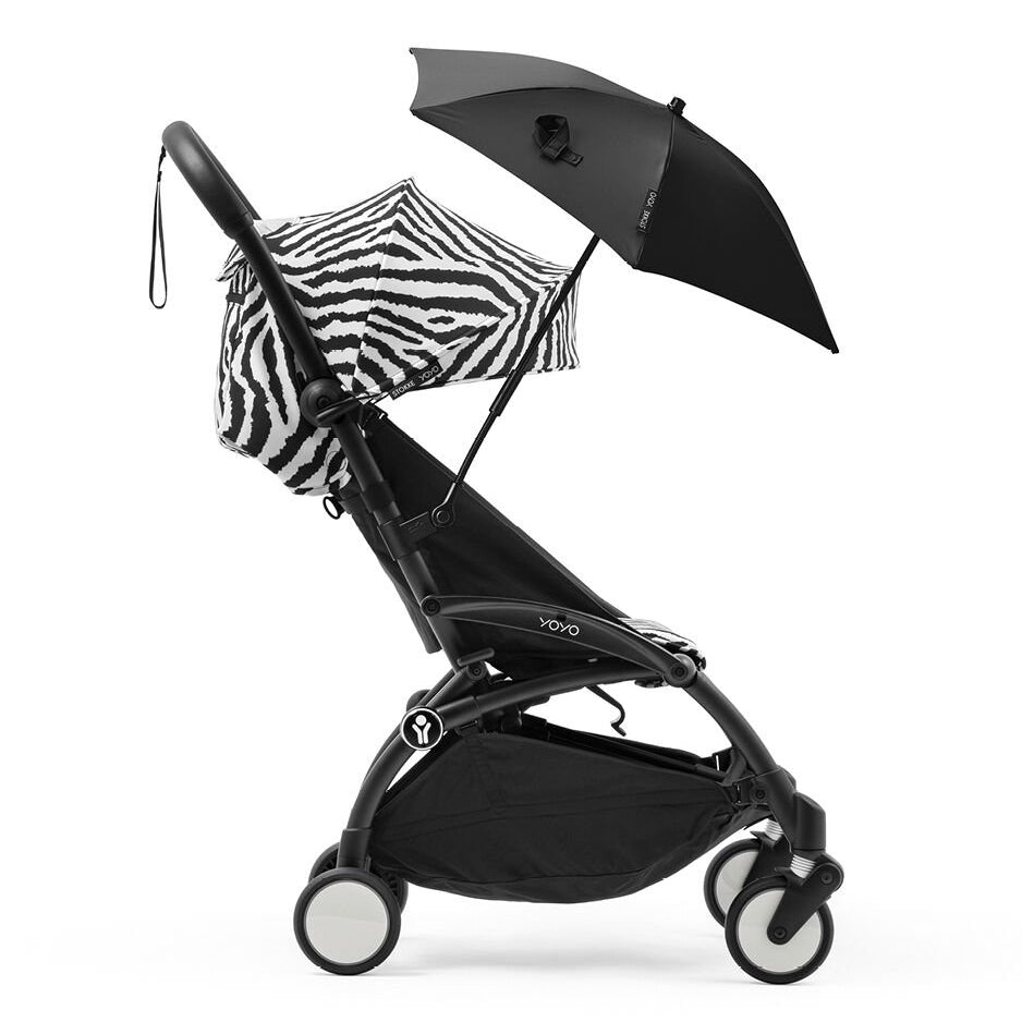 Black stroller with a zebra-patterned sunshade and black umbrella on a white background