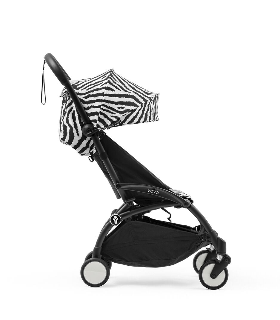 Black stroller with zebra-patterned canopy on a white background