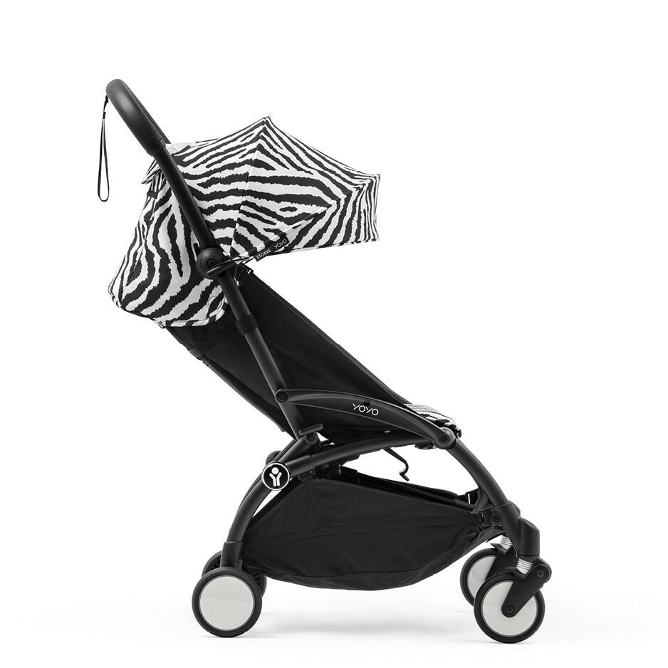 Black stroller with zebra-patterned canopy on a white background