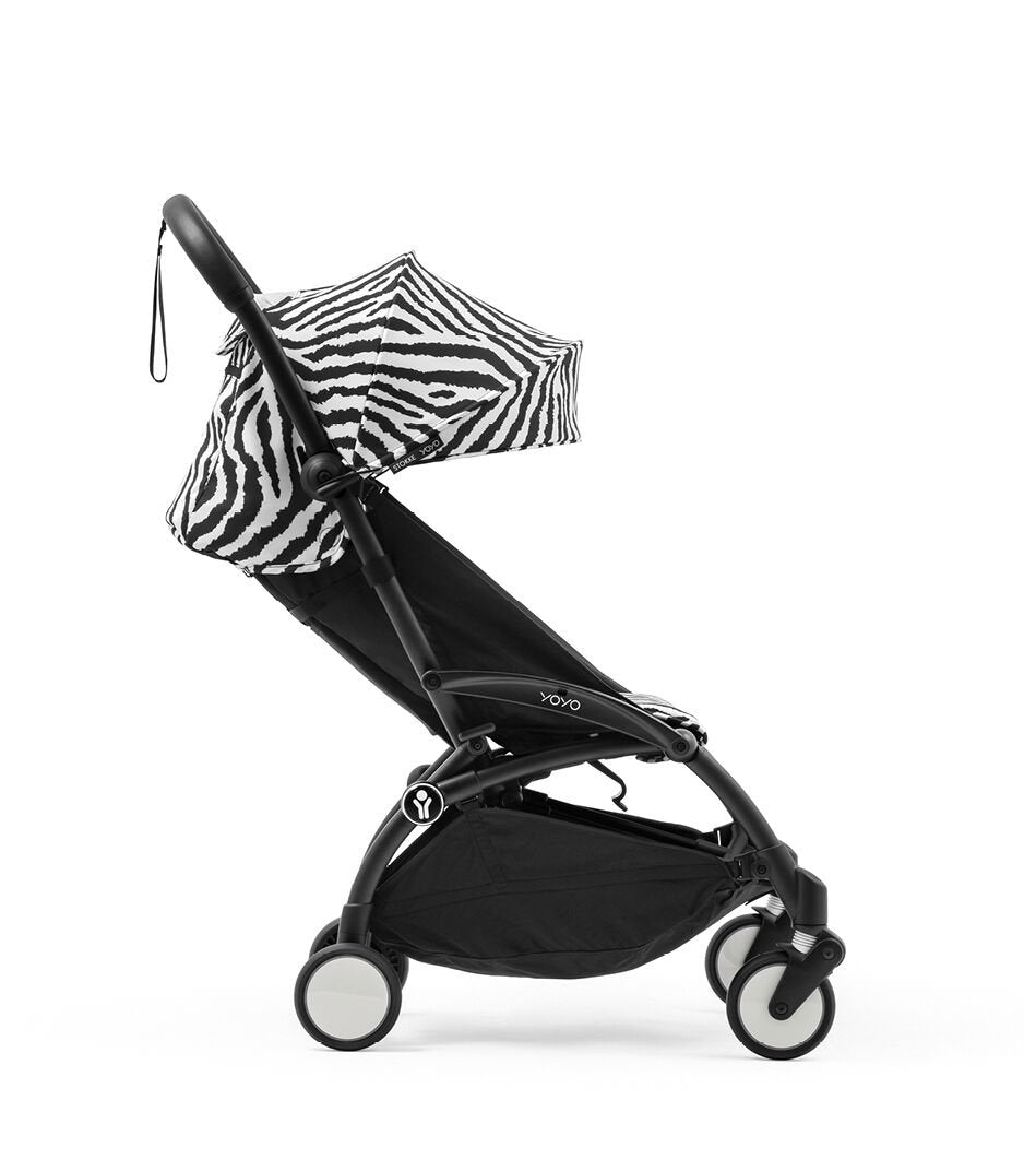 Black stroller with zebra-patterned canopy on a white background