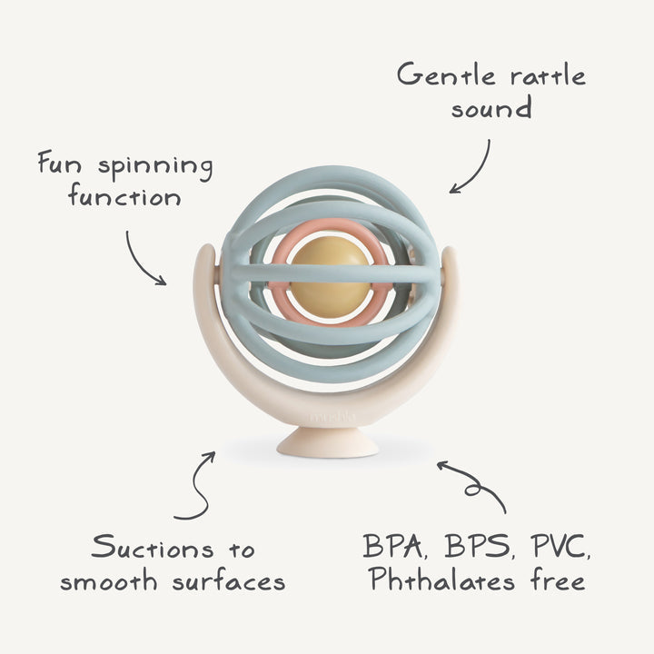 A product feature graphic of the Mushie Suction Spinner Ball pointing out its fun spinning function, gentle rattle sound, suction base, and BPA-free materials.