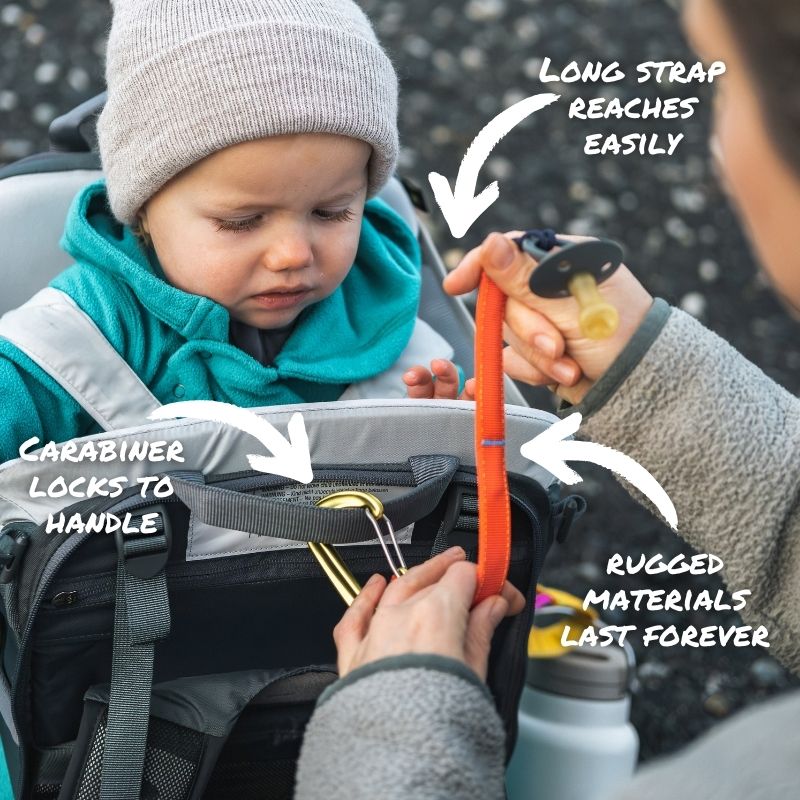 Child in a stroller with a carabiner attached, highlighting features like long strap, carabiner locks, and rugged materials.