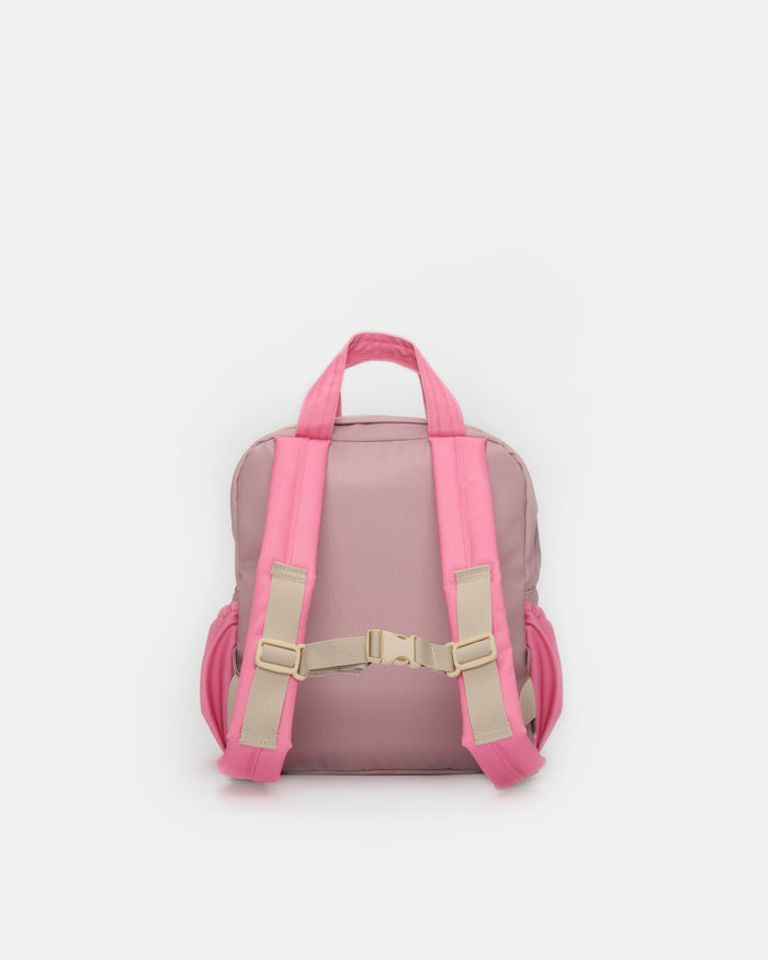 A pink backpack shown from the back, featuring bright pink shoulder straps and side pockets with beige adjustable buckles, set against a plain light gray background.
