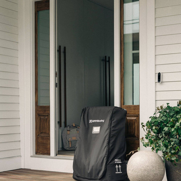 Black storm door cover on a front porch with a house in the background