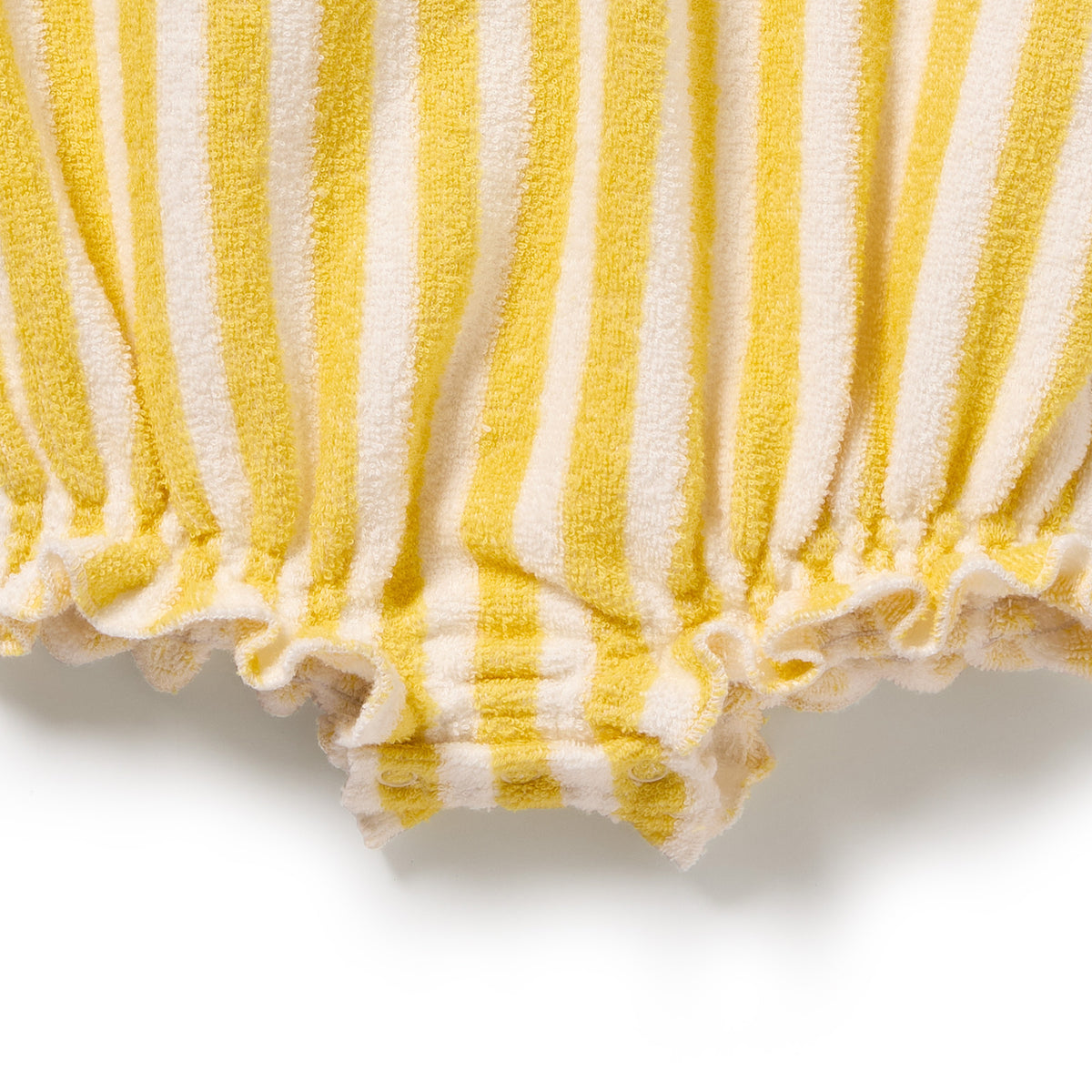 Close-up of yellow and white striped fabric with a textured pattern on a white background