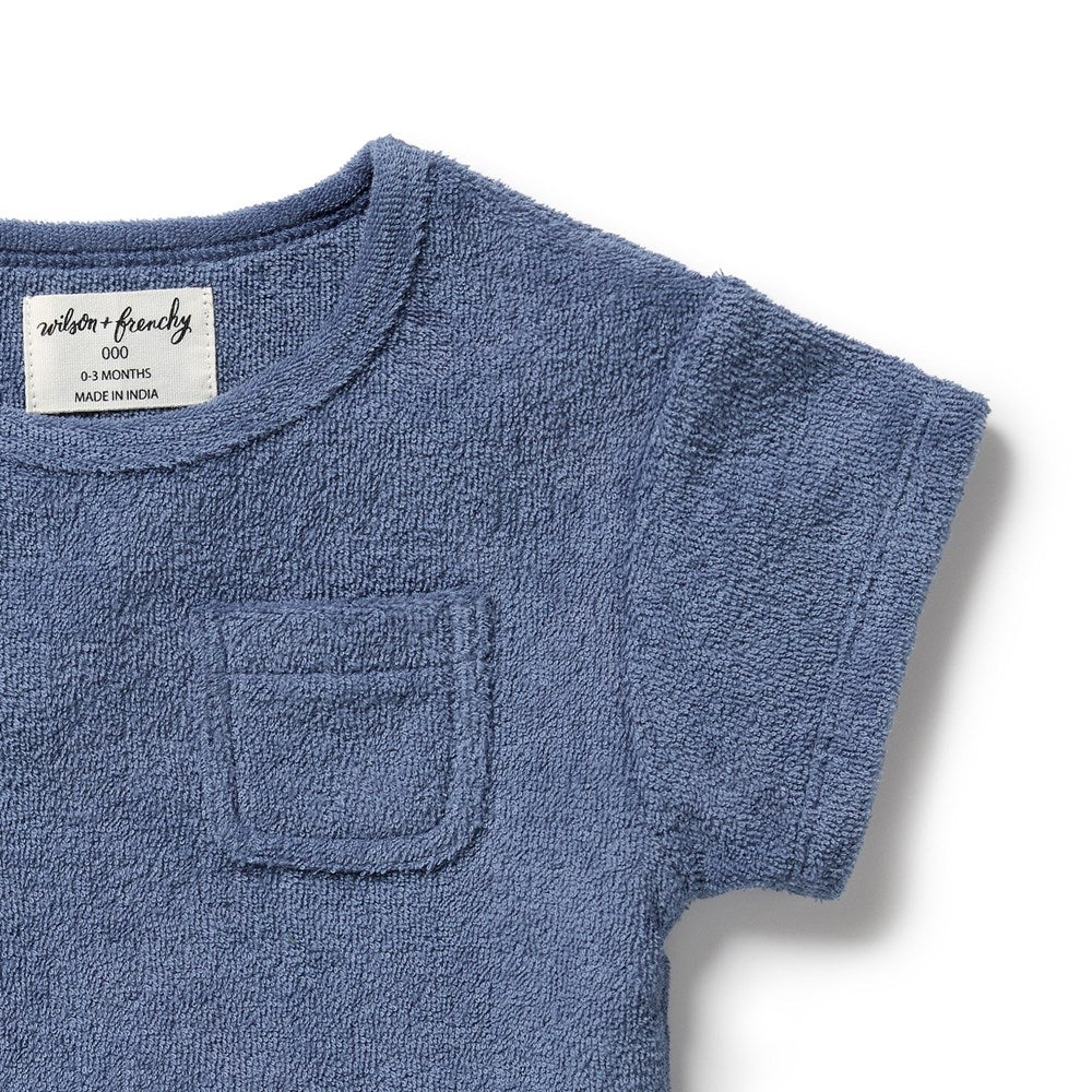 Blue baby outfit with a pocket on a white background