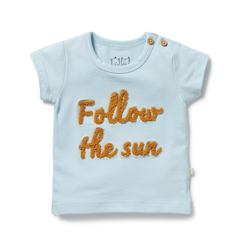 Light blue t-shirt with 'Follow the sun' text on a white background