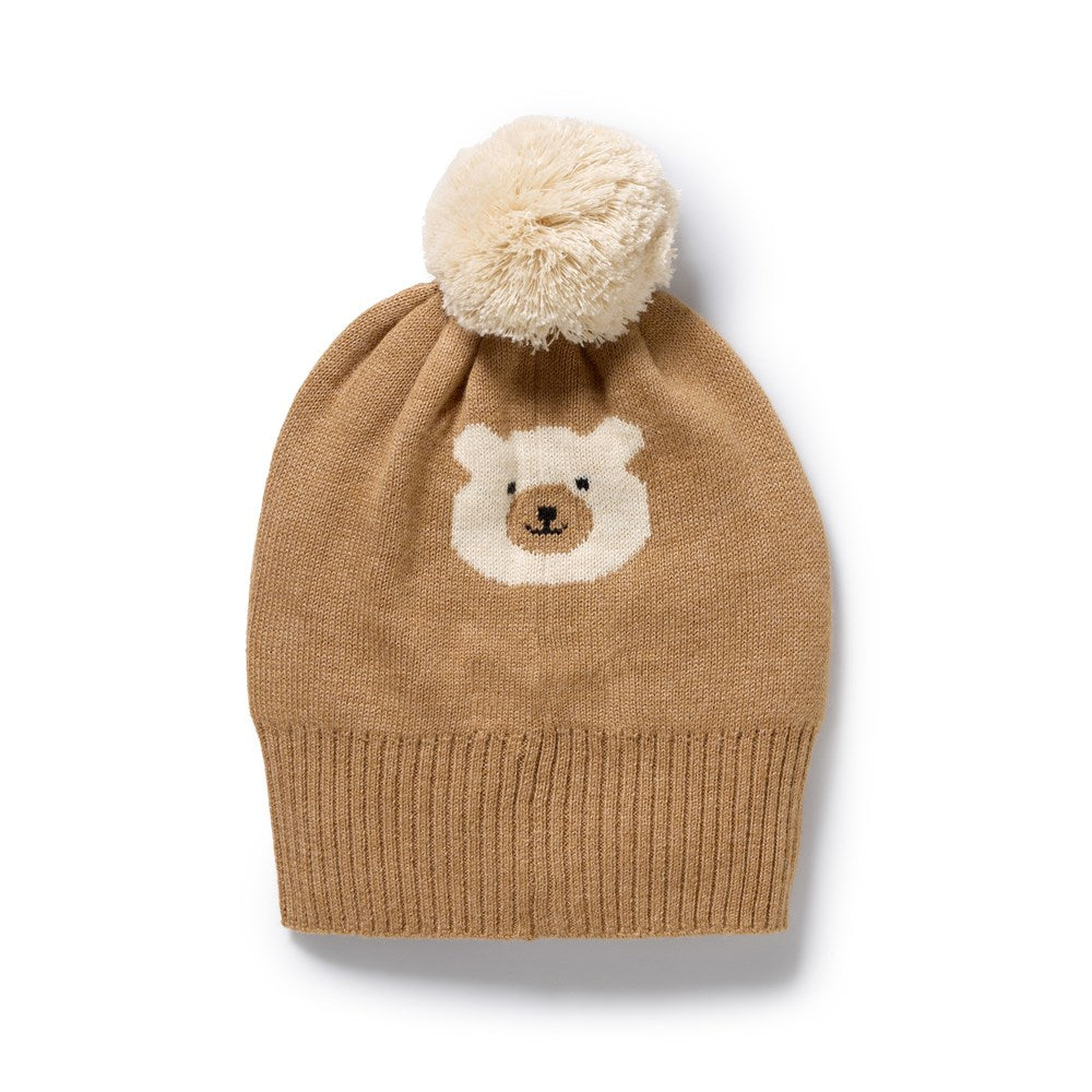 Brown knit beanie with bear face design and pom-pom on a white background