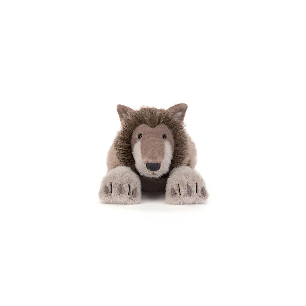 A plush stuffed animal of a brown and beige wolf or wild cat, lying down with its front paws extended, photographed against a seamless white background.