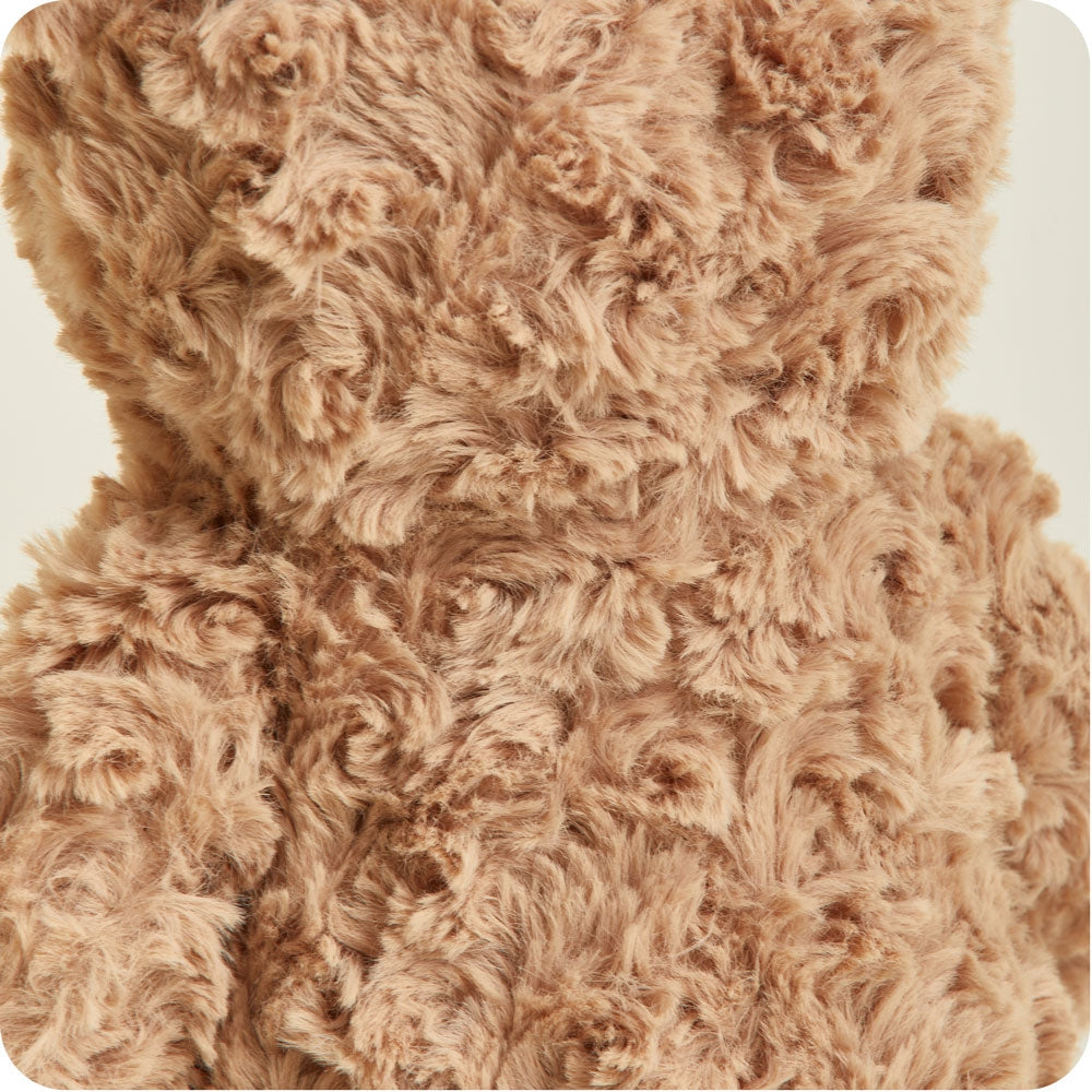 Close-up of a brown teddy bear with textured fur on a white background
