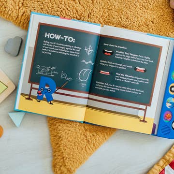 Open book with educational content on a yellow textured surface