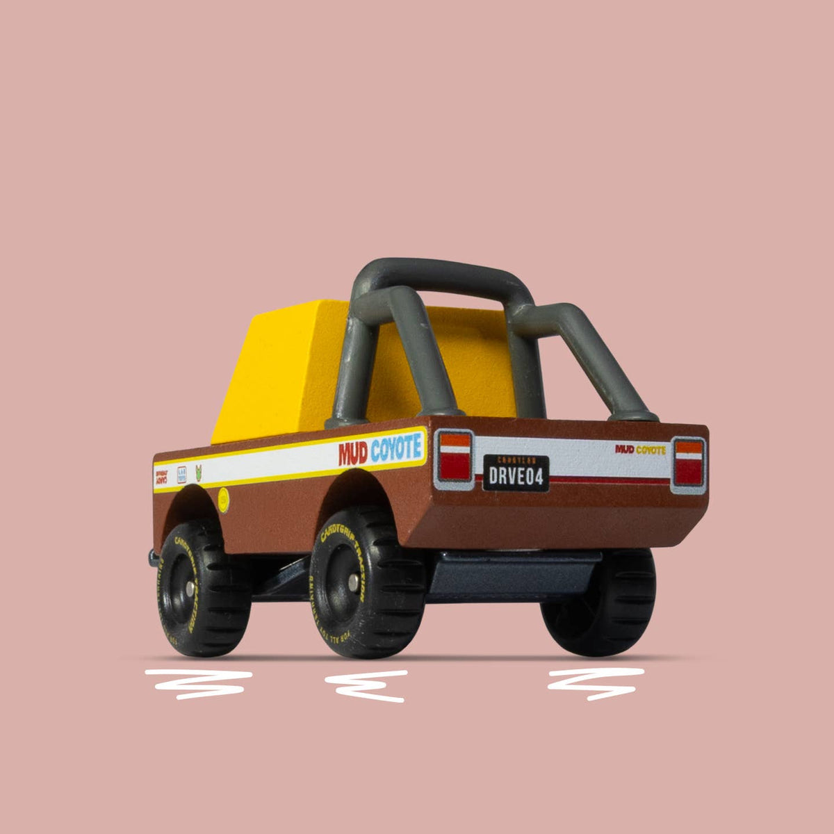 Toy truck with a yellow bed and brown body on a pink background