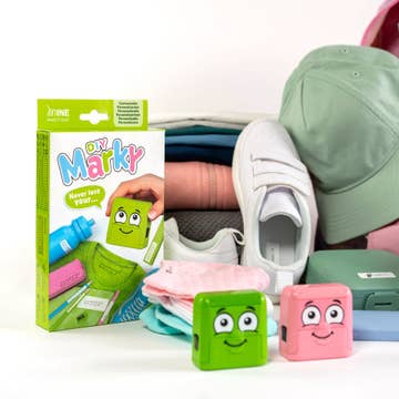 Green and pink blocks with cartoon faces on a white surface, next to a box labeled 'Mr. Marky'.