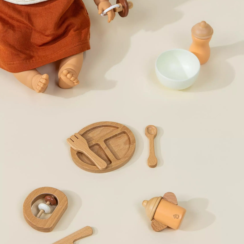 Wooden toys and a doll on a neutral background