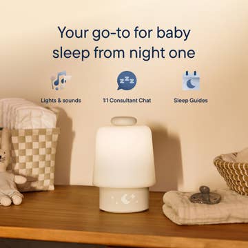 Baby night light with text 'Your go-to for baby sleep from night one' on a wooden surface.