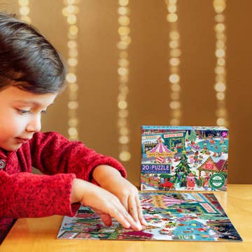 Child playing with a Christmas-themed puzzle on a table with a blurred festive background