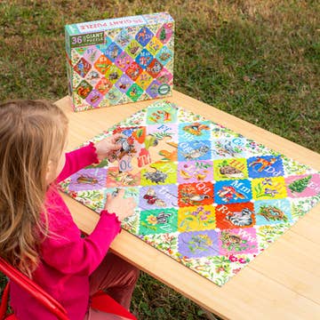 Child playing with a colorful puzzle on a wooden table outdoors