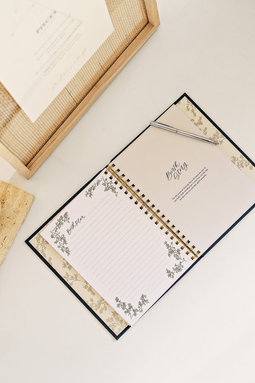 Notebook with decorative cover and pen on a light surface