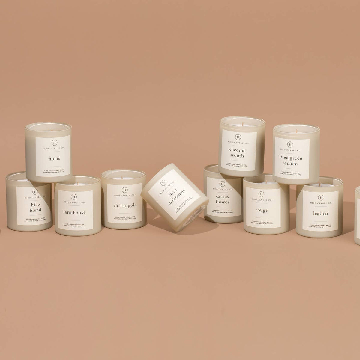 Assorted candles with labels on a beige background