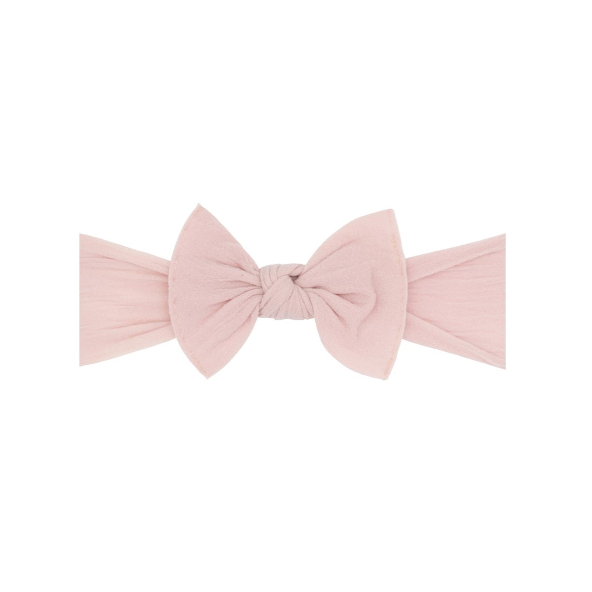 A light pink fabric headband with a large bow in the center, photographed flat against a solid white background.