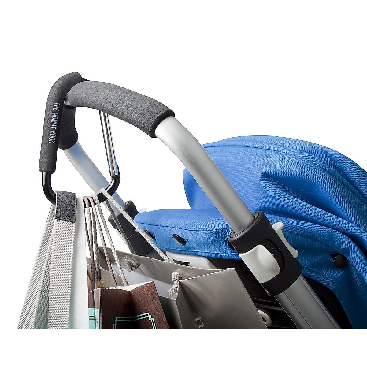 Close-up of a stroller handle with attached bags on a white background