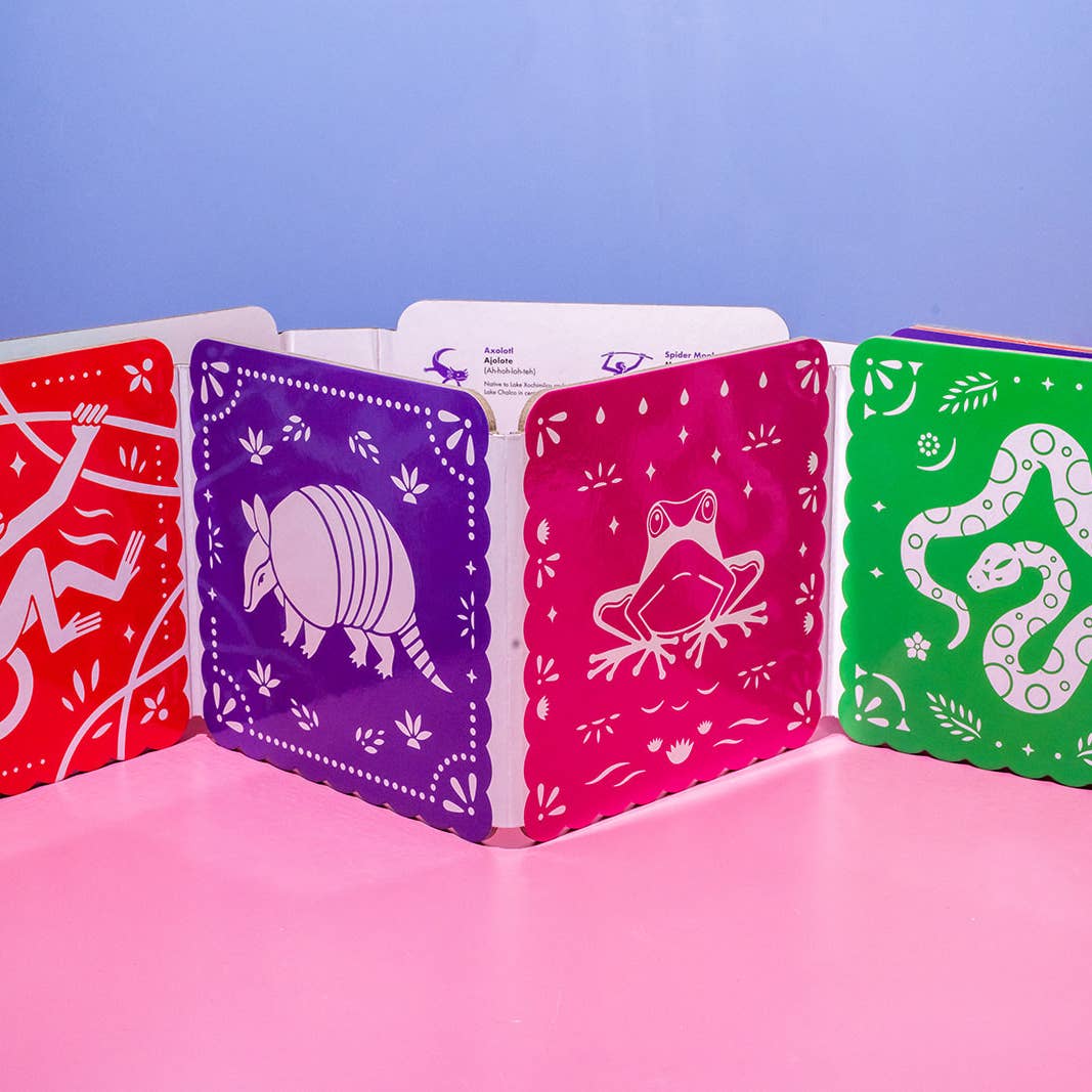 Set of colorful playing cards with animal illustrations on a pink surface and blue background