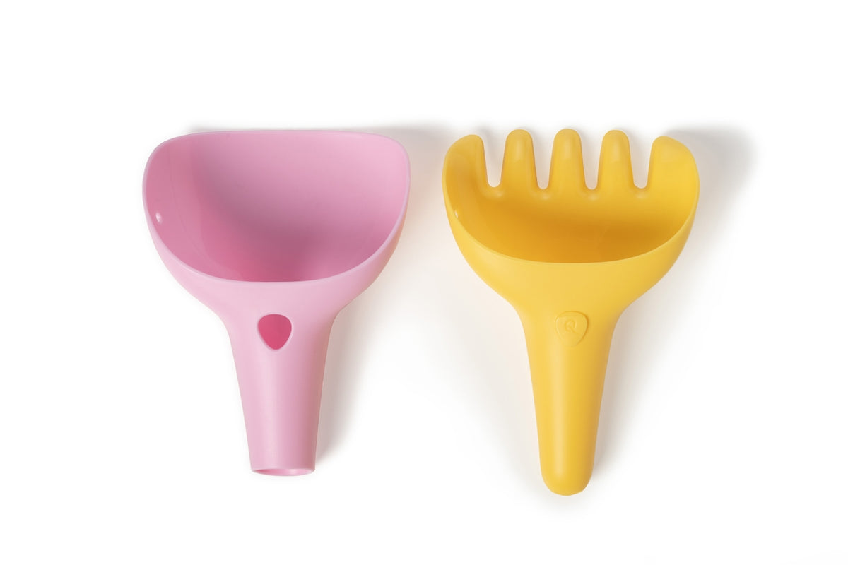 A pink digger toy and a yellow rake toy resting side-by-side on a plain white background.