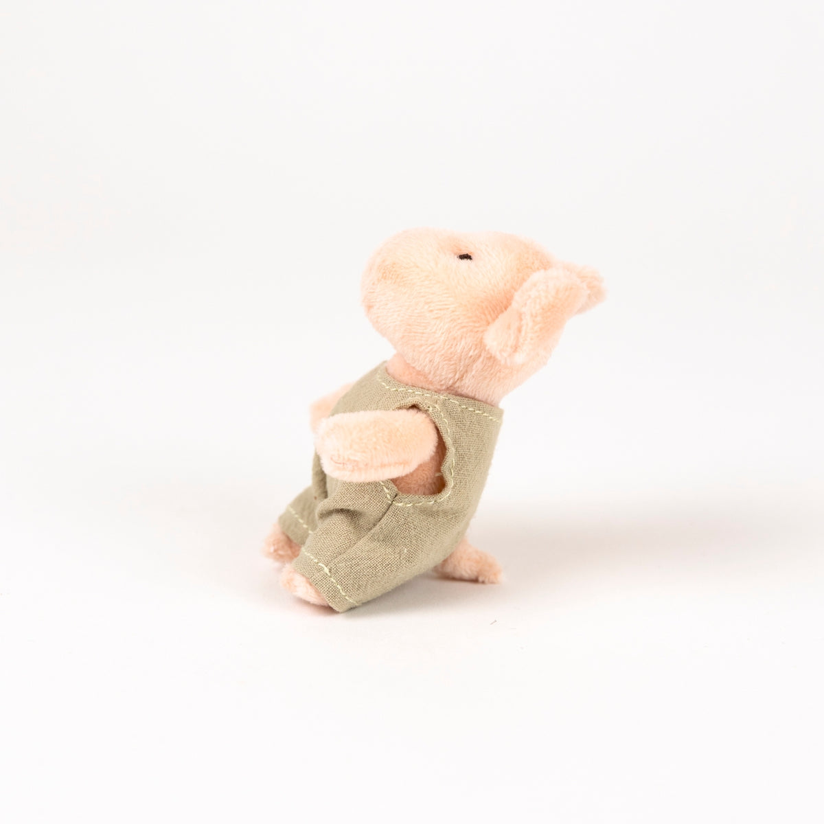 plush pink pig with beige romper - view from the side