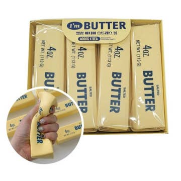 Packaging of 'I'm Butter' salted butter sticks with a close-up of a hand holding one stick.