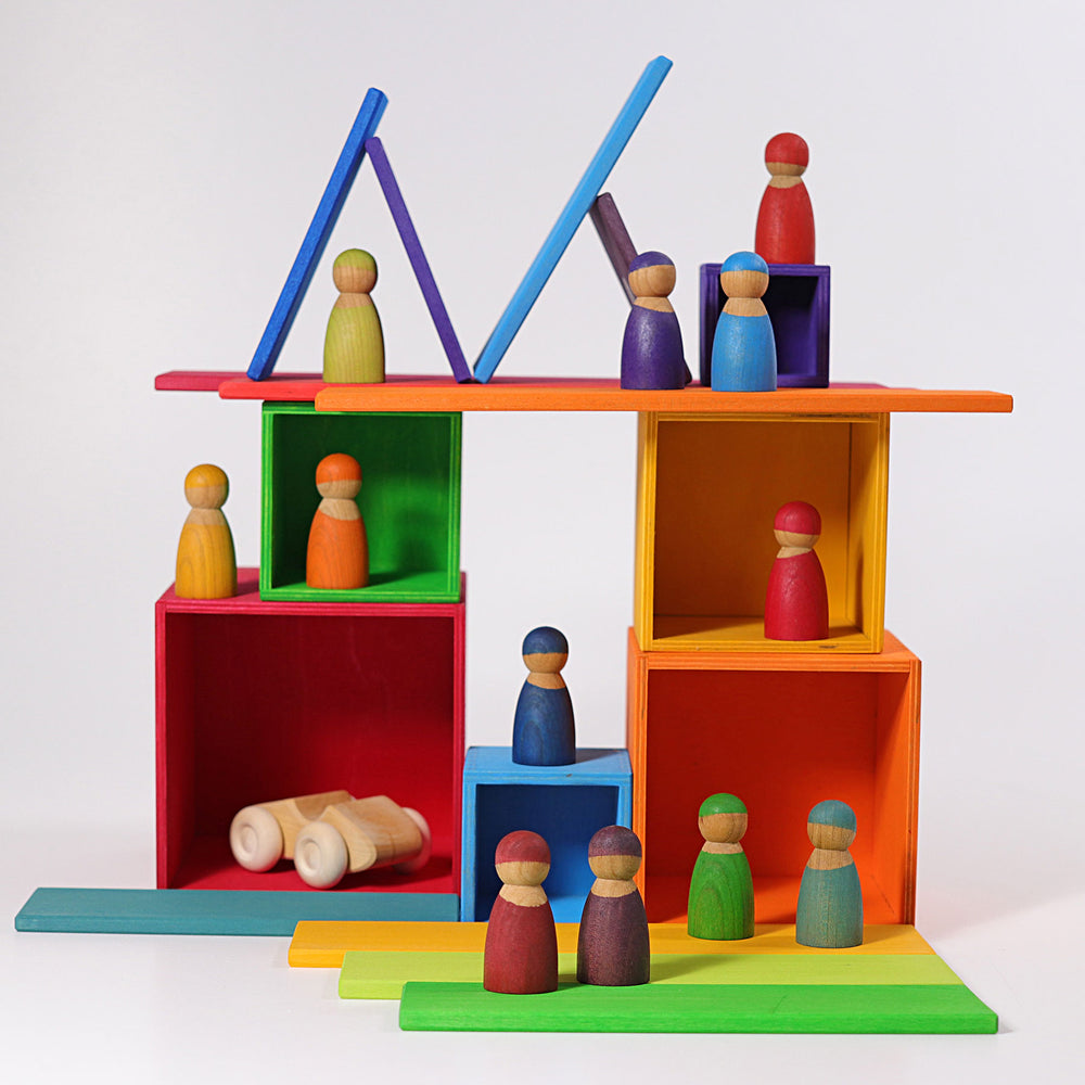 Colorful wooden toy set with peg people and geometric shapes on a white background