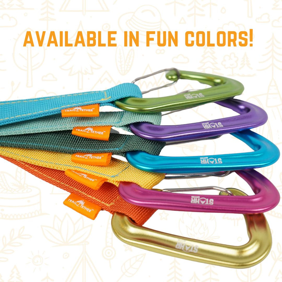 Set of colorful carabiners with visible brand name on a patterned background