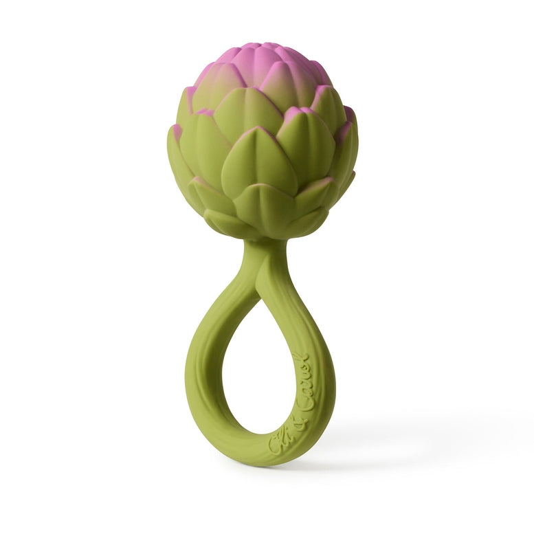 Oli & Carol Artichoke Rattle Toy featuring a textured, bulbous pink-and-green artichoke top attached to a smooth, easy-to-grasp green ring handle, shown upright against a clean white background.