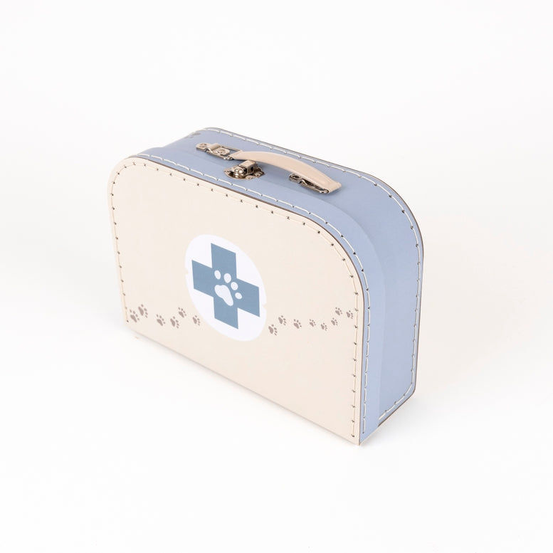 A miniature faux leather medical-style case designed for pets, featuring a cream-colored front with a blue paw-print cross emblem, a light blue side panel, and a beige handle with gold-tone hardware, set against a plain white background.