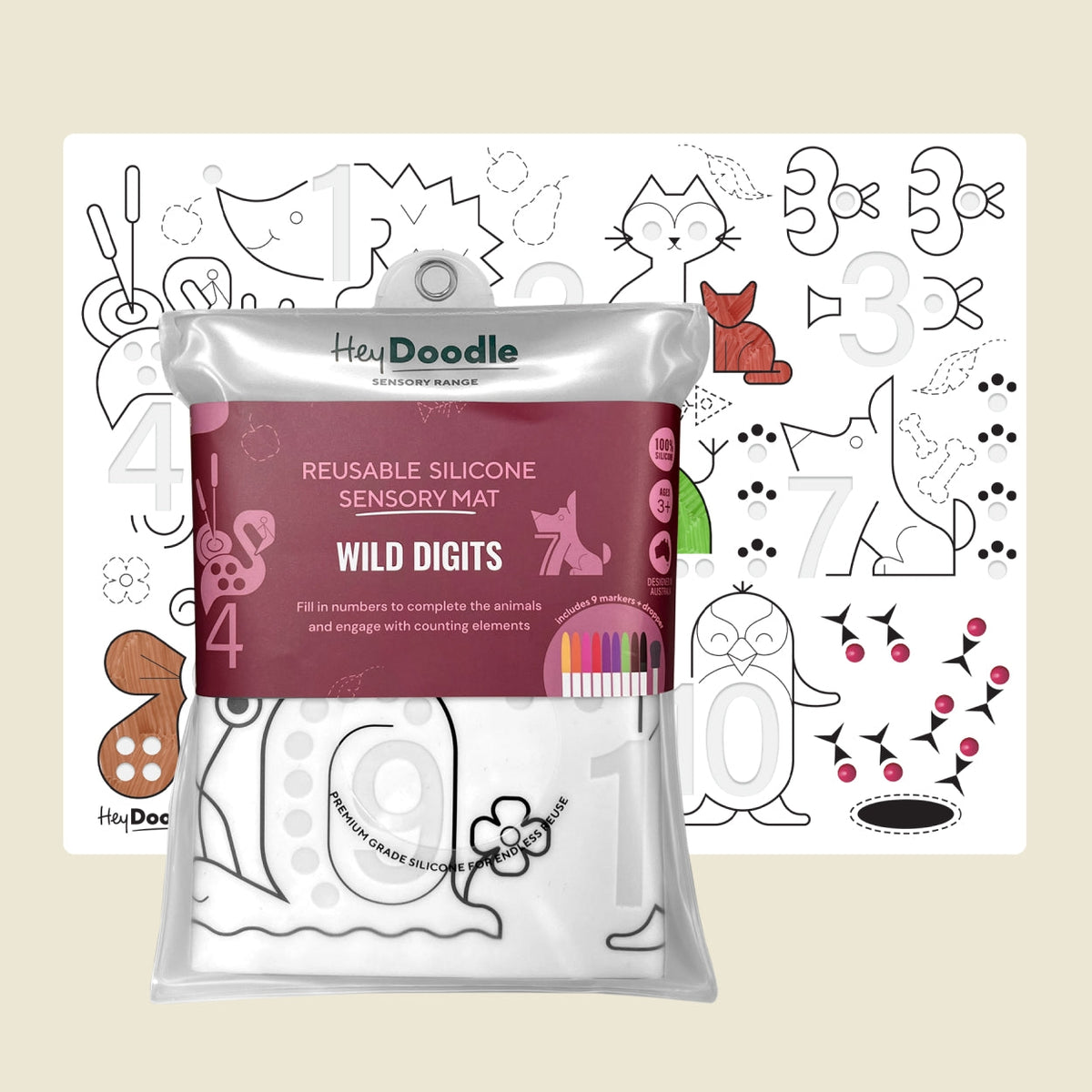 Heidi Doodle Reusable Silicone Sensory Mat 'Wild Digits' in a silver resealable pouch, shown in front of an example coloring page featuring numbers and animal shapes on a light beige background.