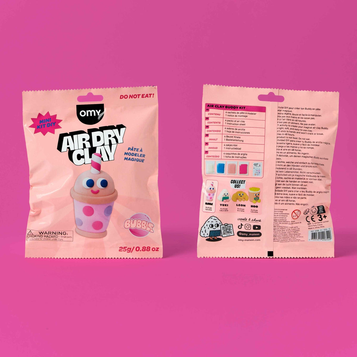 Two pink Omy Air Dry Clay bags shown side by side on a solid pink background, with the front of one bag on the left and the back of the other on the right.