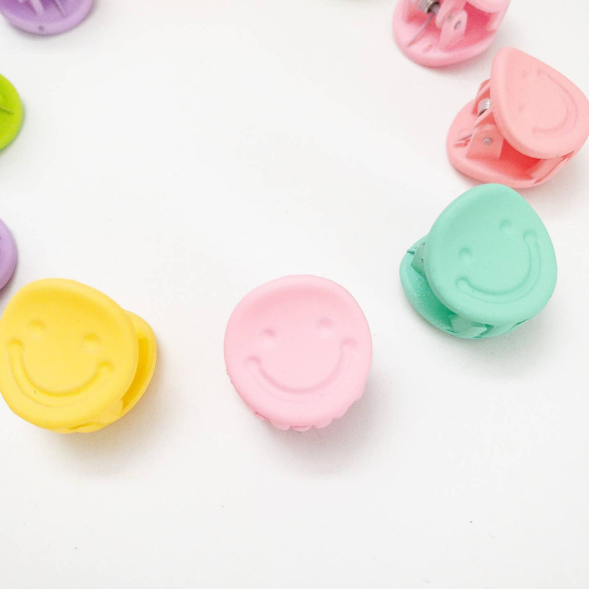 Colorful smiley face clips on a white background