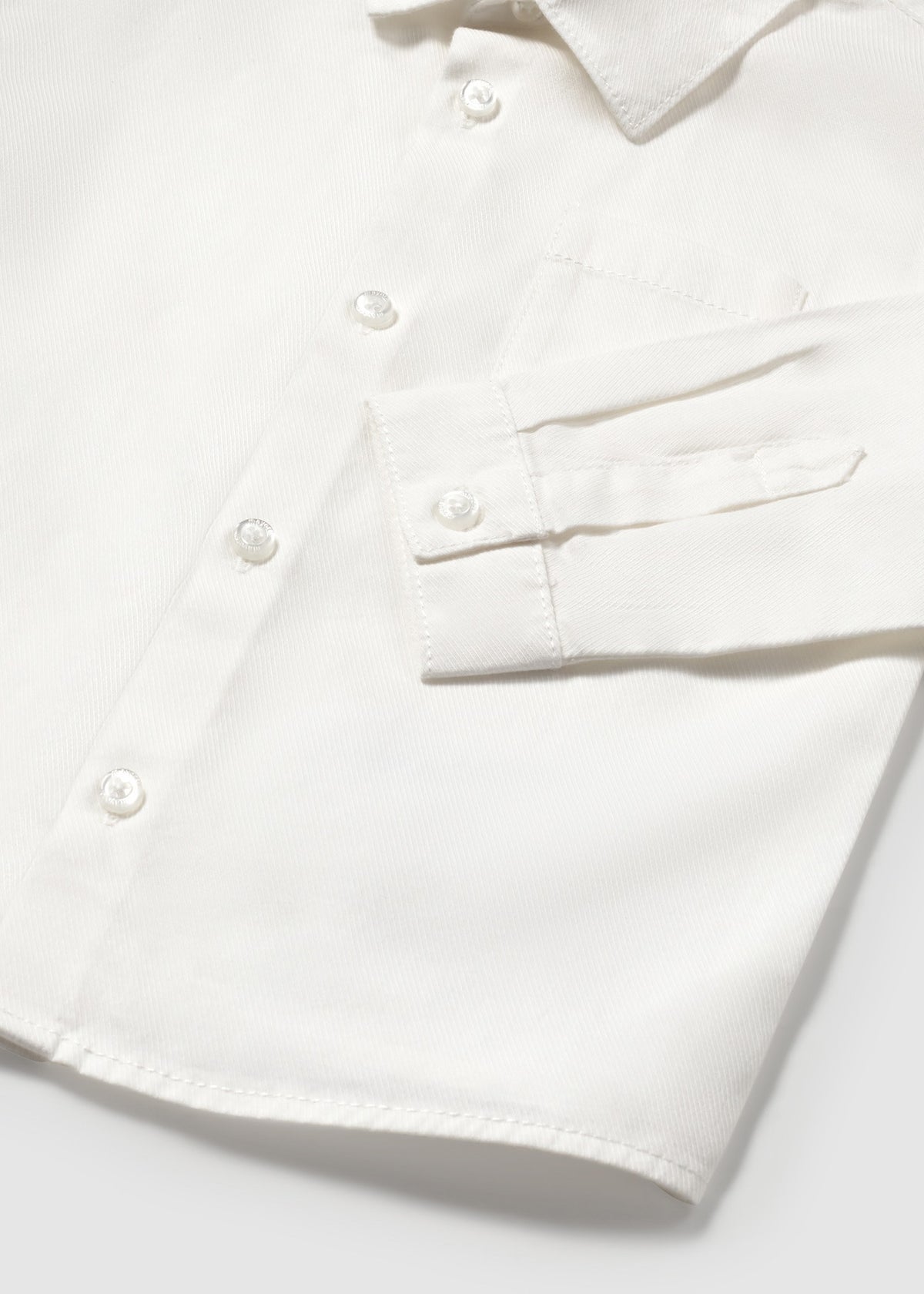White shirt with buttons on a light gray background