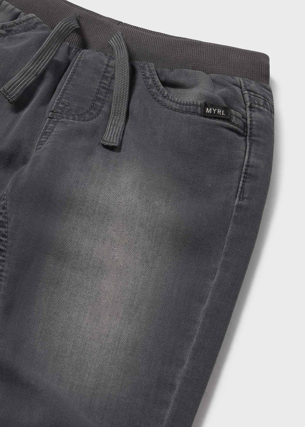 Dark gray pants with a brand label on a light gray background