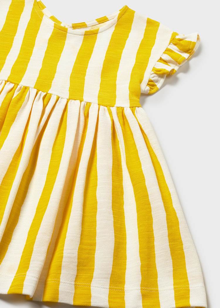 Yellow and white striped dress on a light gray background