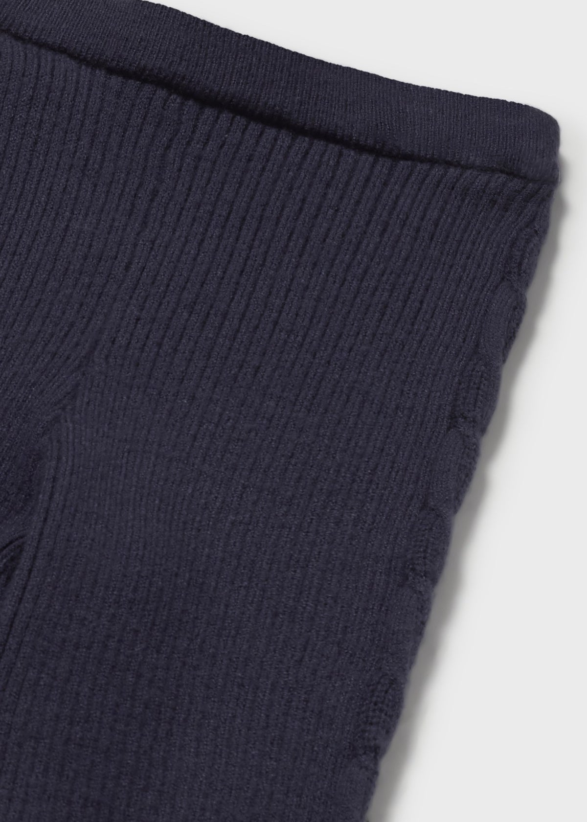 Navy ribbed knit fabric on a white background