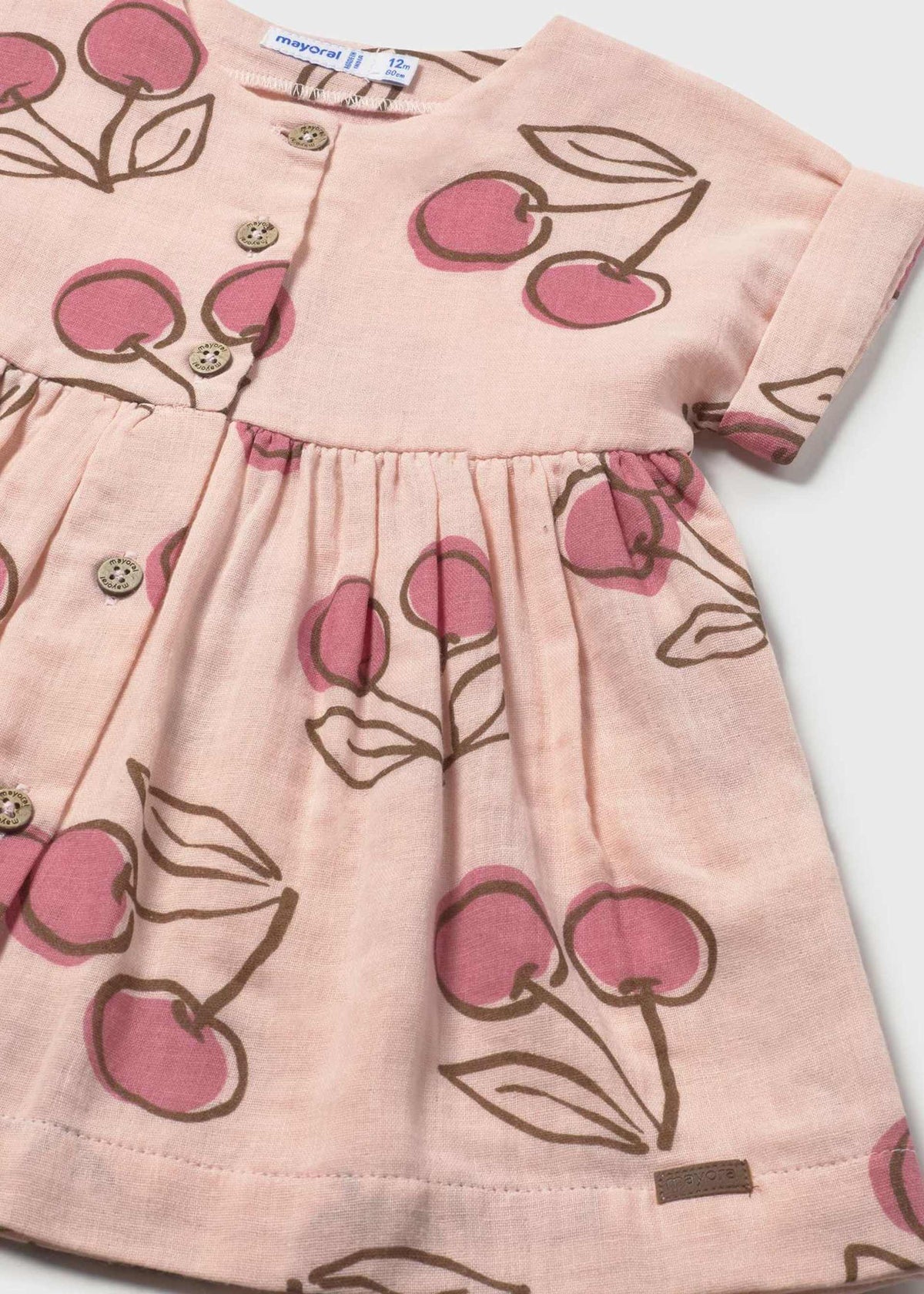 Pink dress with cherry pattern on a white background
