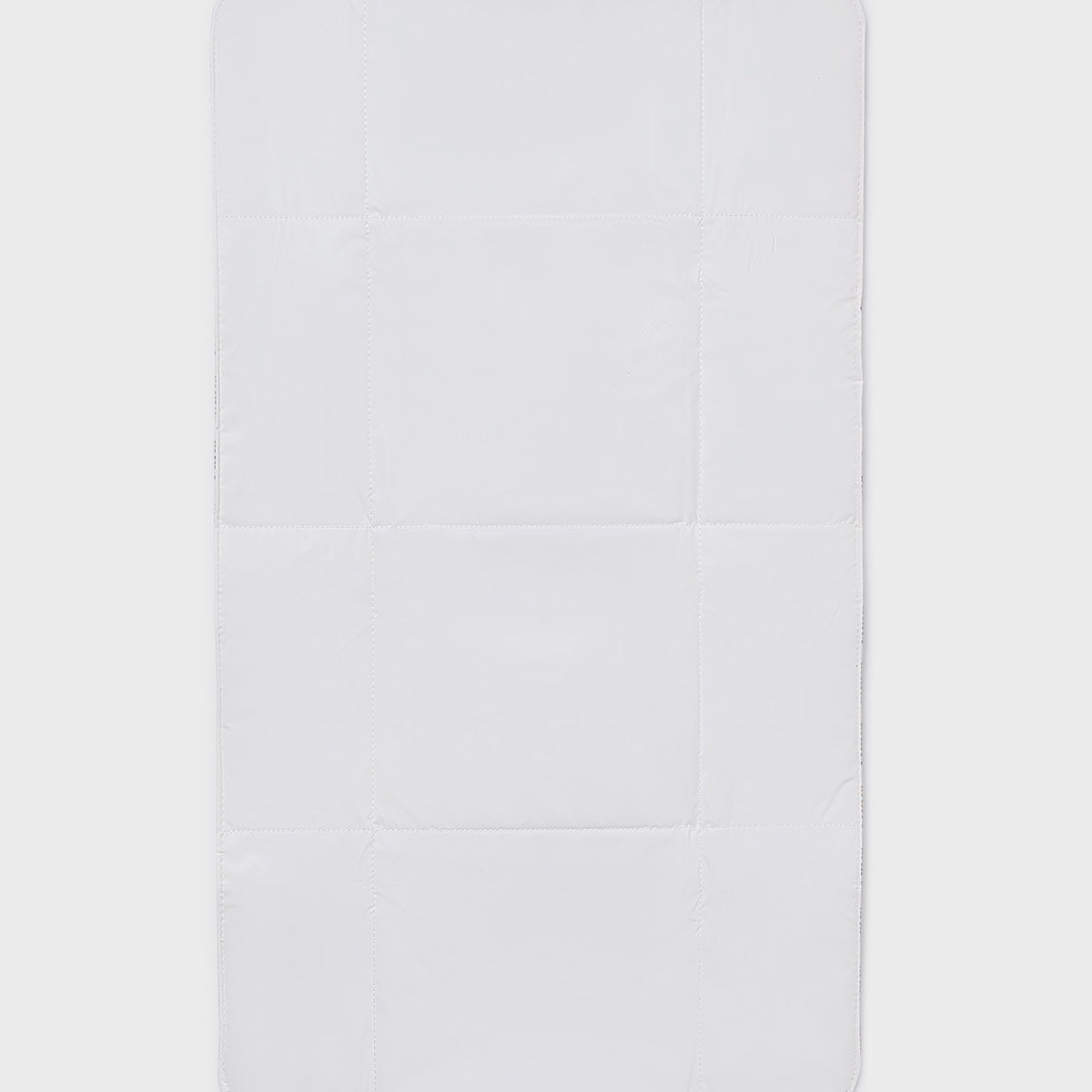 Rectangular white bath mat on a light gray background