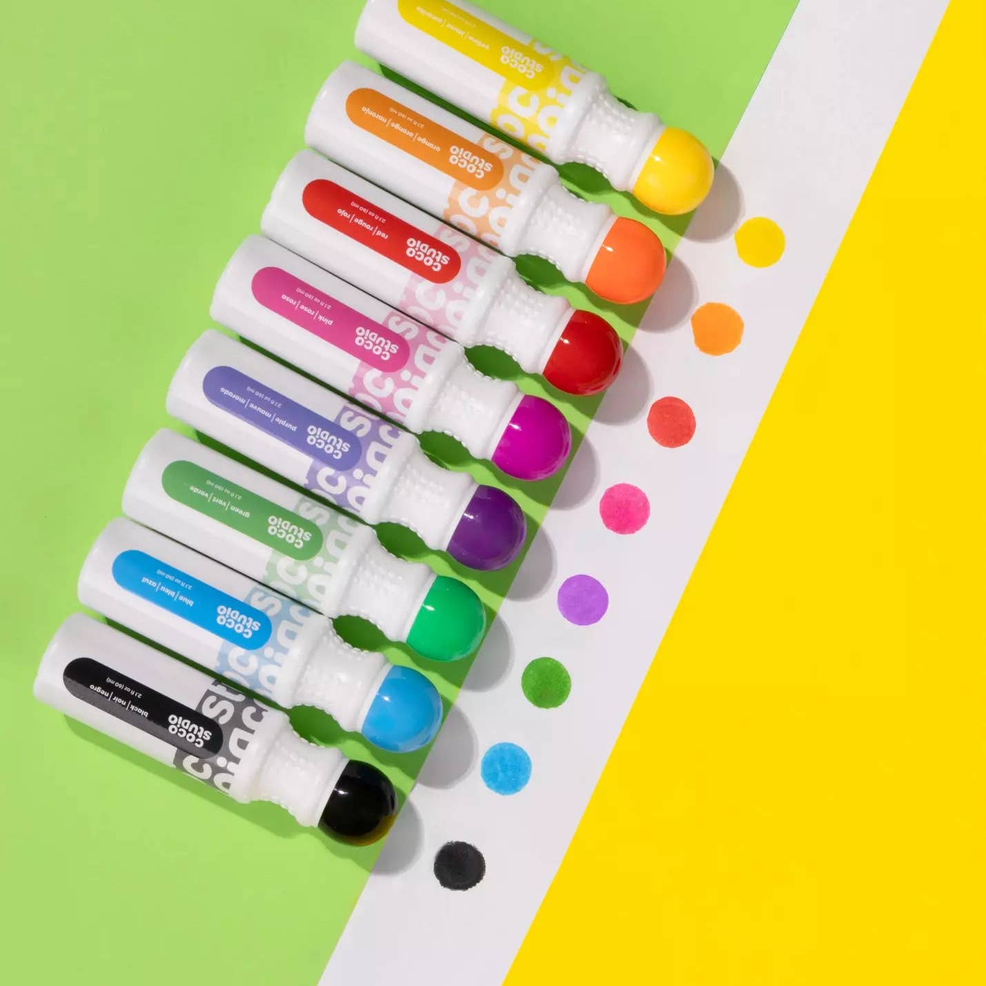 Set of colorful markers on a green and yellow background